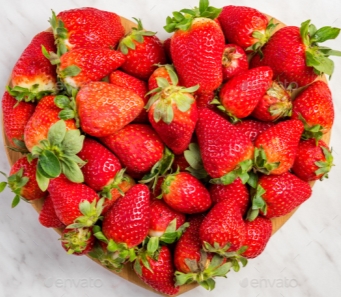 Heart shape strawberries on white marble, love for fresh fruits Stock Photo  by merc67